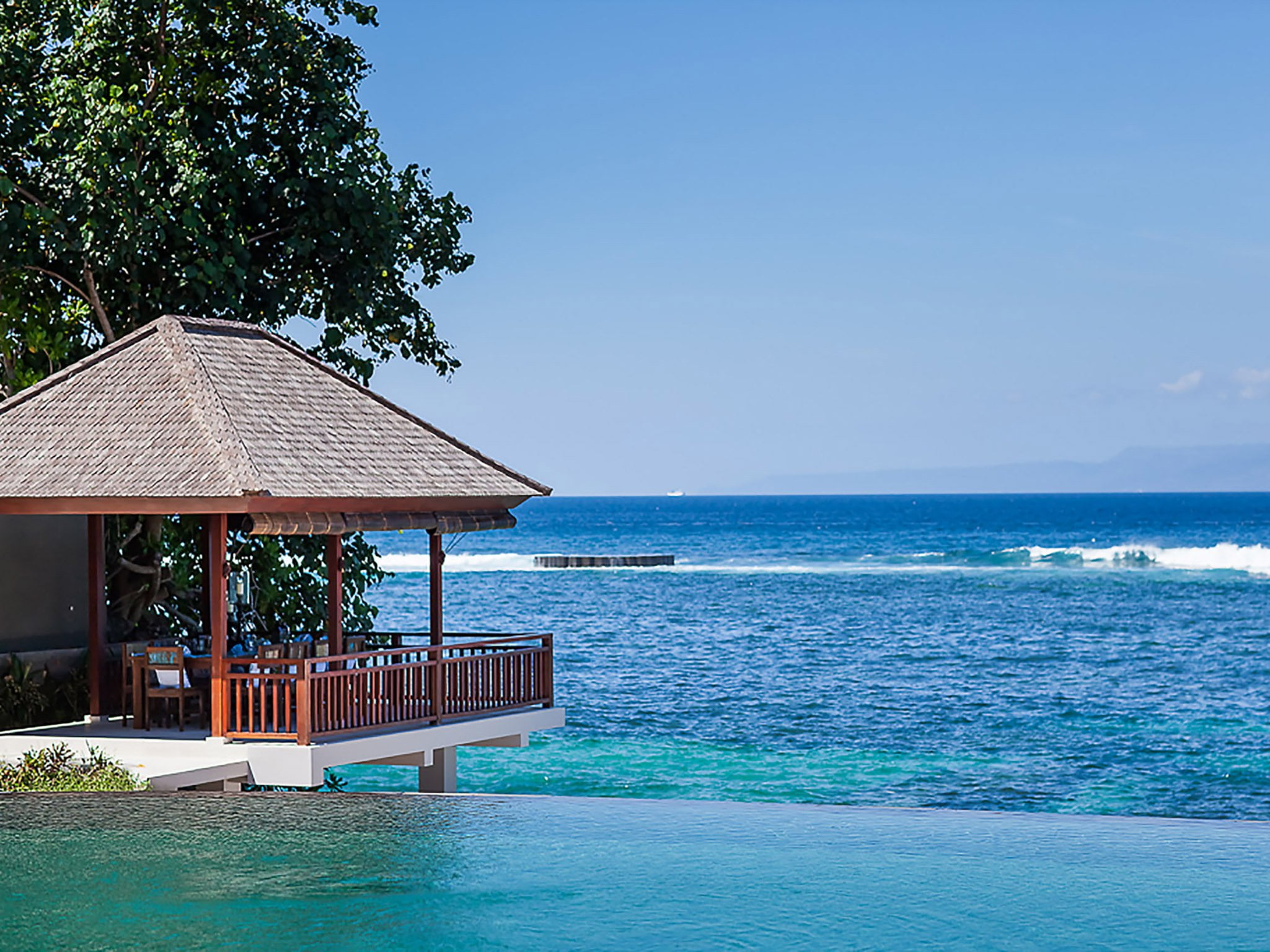 13. villa tirta nila outdoor dining hanging above crystal clear waters