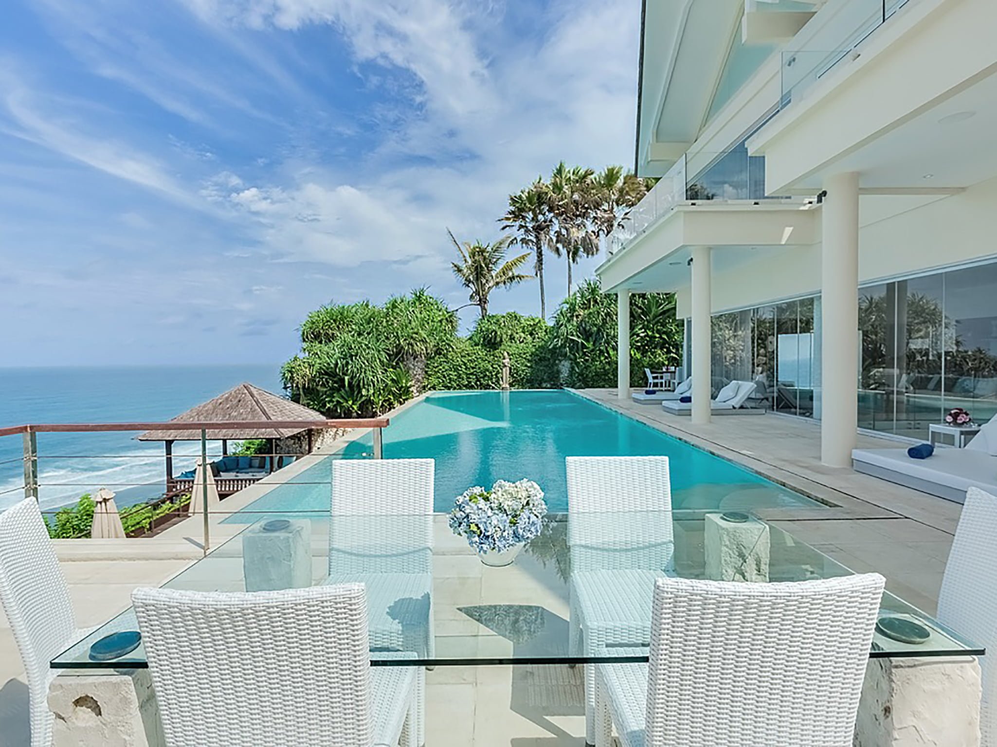 2. grand cliff front residence dinner table pool side