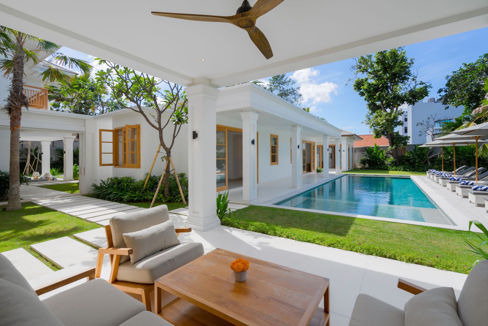 amenara kanan pool from the main building showing the far end room + view from right side of outdoor living room through sliding doors towards sunken living room